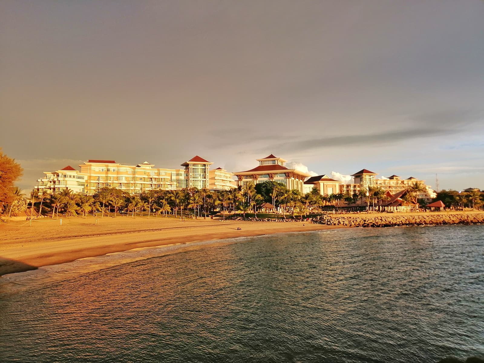 The Empire Brunei resort and its beach in warm evening light
